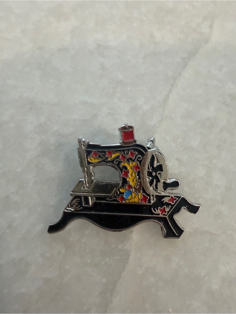 Vintage Black Sewing Machine Brooch with Red and Yellow Accents